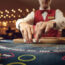 The croupier holds poker cards in his hands at a table in a casino.